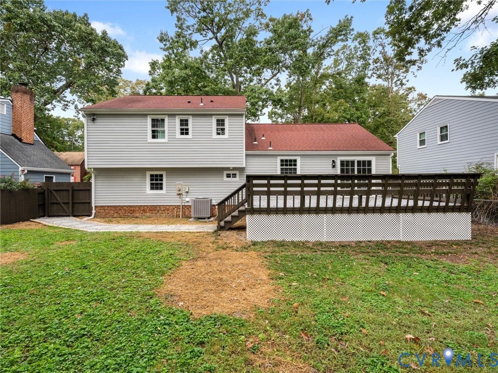 2031 Esquire Road, Midlothian, VA 23235 Spacious rear deck with dark wood-finish railings, light gray siding, and a red roof