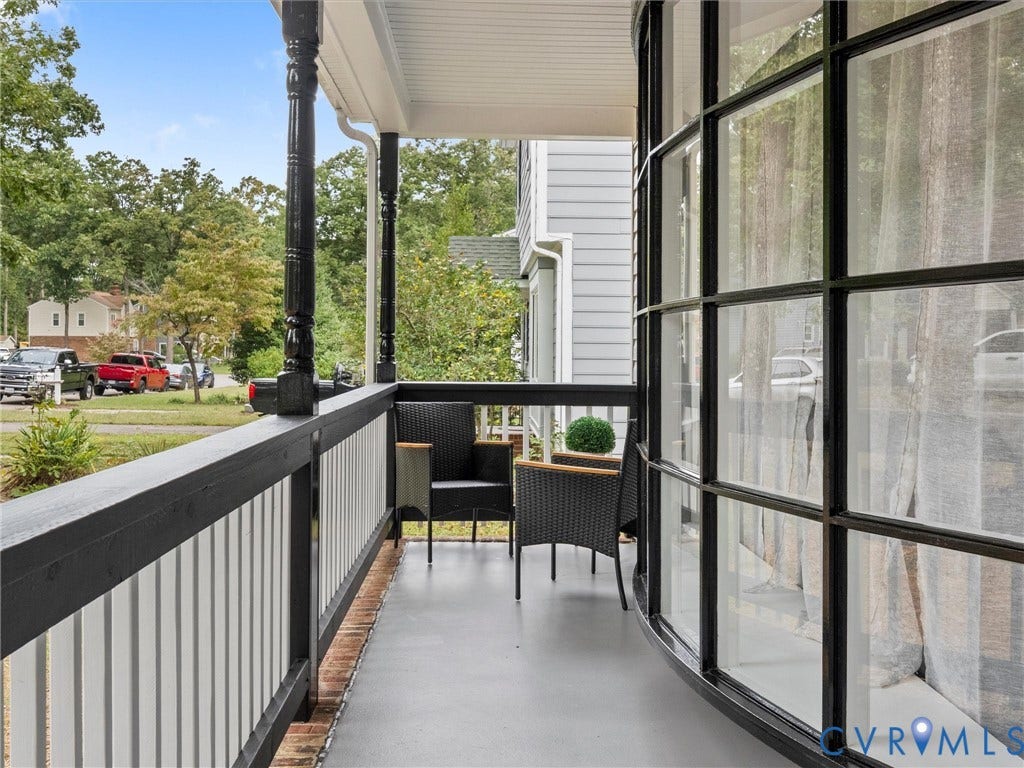 2031 Esquire Road, Midlothian, VA 23235 Covered porch with decorative columns, white vertical railings, and a solid balcony floor