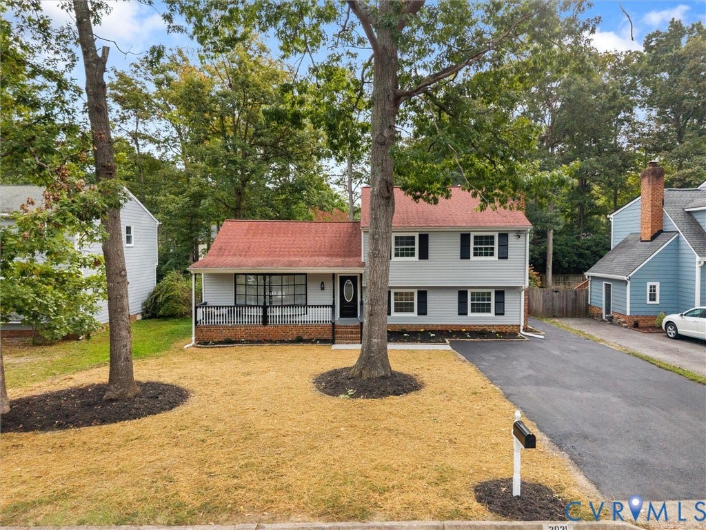 2031 Esquire Road, Midlothian, VA 23235 Split-level residence featuring a covered front porch, red roof, black shutters, and an asphalt driveway