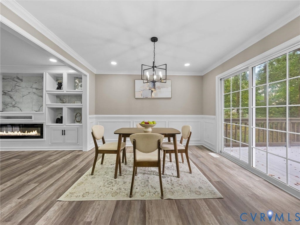 2031 Esquire Road, Midlothian, VA 23235 Wood-finish flooring, wainscoting, sliding glass door, recessed lighting, and a modern chandelier