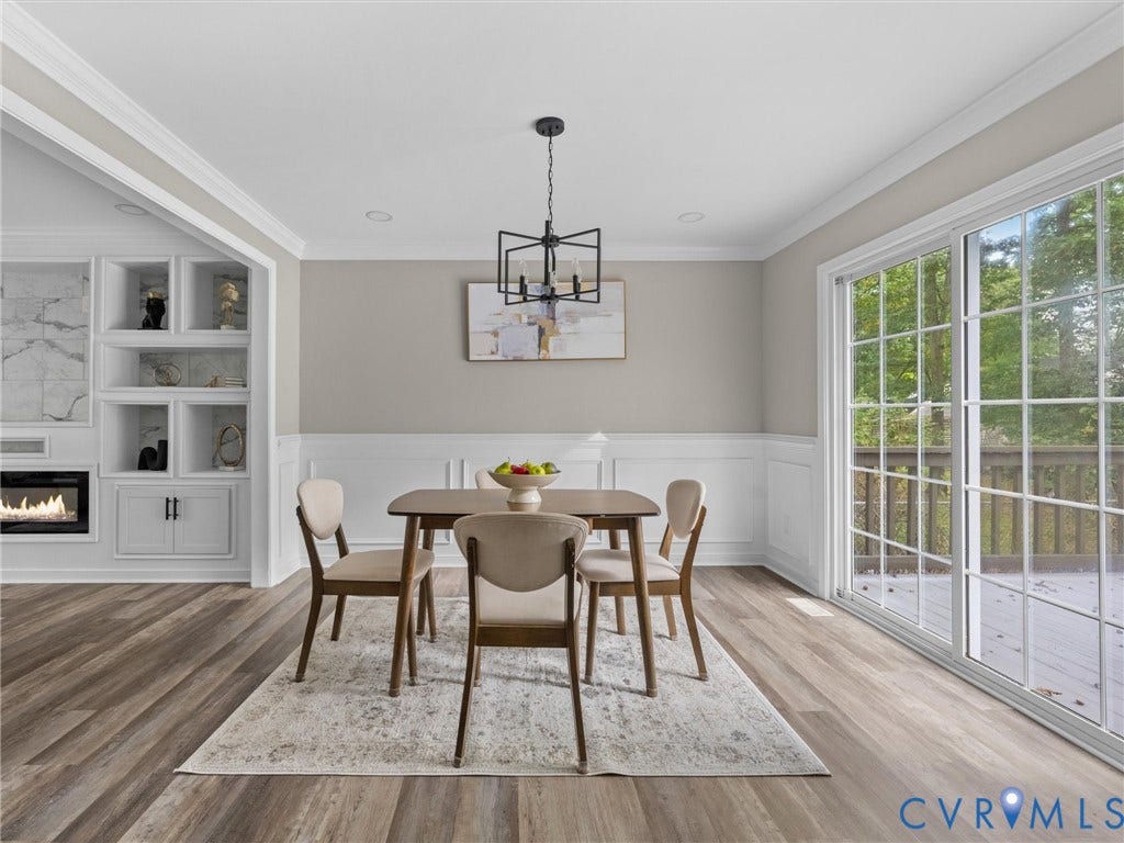 2031 Esquire Road, Midlothian, VA 23235 Wood-finish flooring, crown molding, wainscoting, built-in shelving, and a sliding glass door to a deck