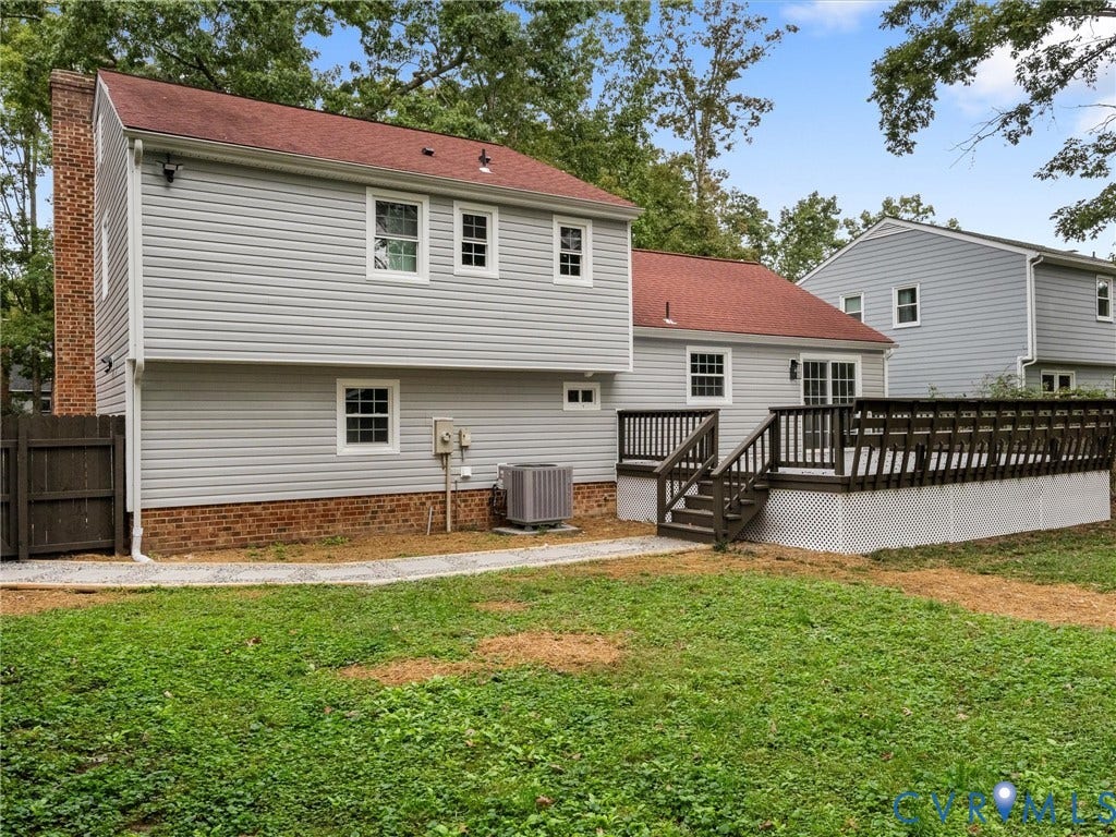2031 Esquire Road, Midlothian, VA 23235 Spacious outdoor deck with dark wood railing and lattice skirting, sliding glass door access, and light gray siding