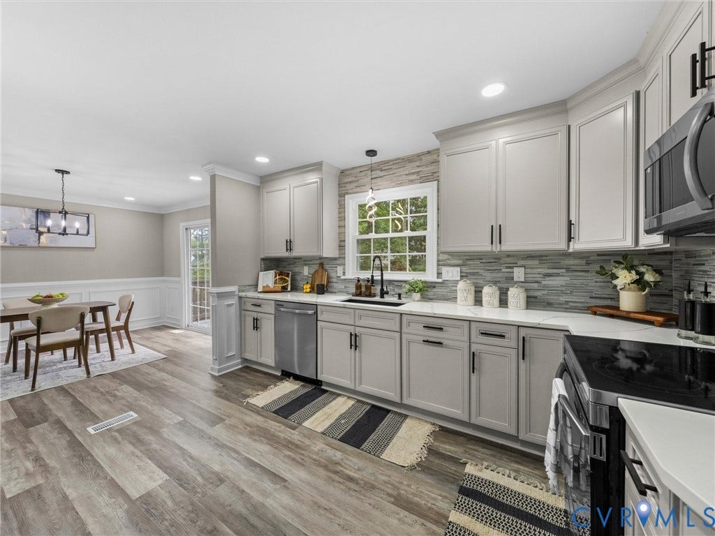 2031 Esquire Road, Midlothian, VA 23235 Wood-finish flooring, recessed lighting, shaker-style cabinetry, mosaic tile backsplash, and stainless steel appliances