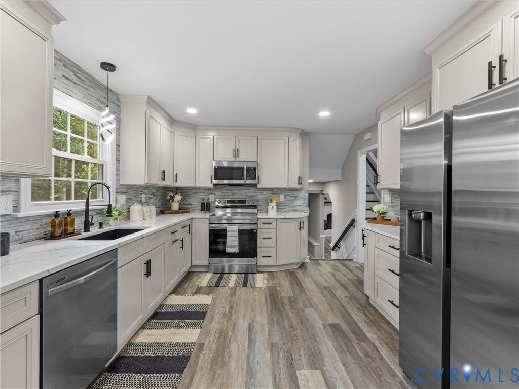 2031 Esquire Road, Midlothian, VA 23235 Kitchen featuring light cabinetry, stainless steel appliances, white countertops, tile backsplash, and wood-finish flooring
