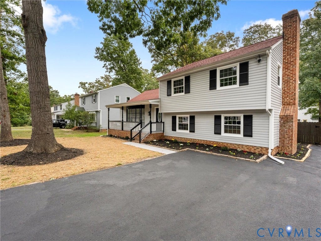 2031 Esquire Road, Midlothian, VA 23235 Split-level home featuring light gray siding, black shutters, and an attached brick chimney
