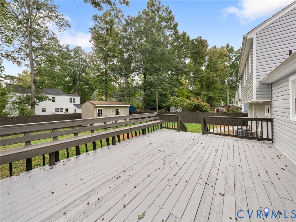2031 Esquire Road, Midlothian, VA 23235 Expansive wood deck with built-in seating, dark wood railings, and a detached shed in the backyard