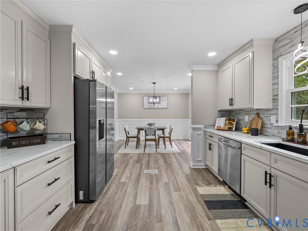 2031 Esquire Road, Midlothian, VA 23235 White cabinetry with matte black hardware, stainless steel appliances, wood-finish flooring, recessed lighting, and a tile backsplash
