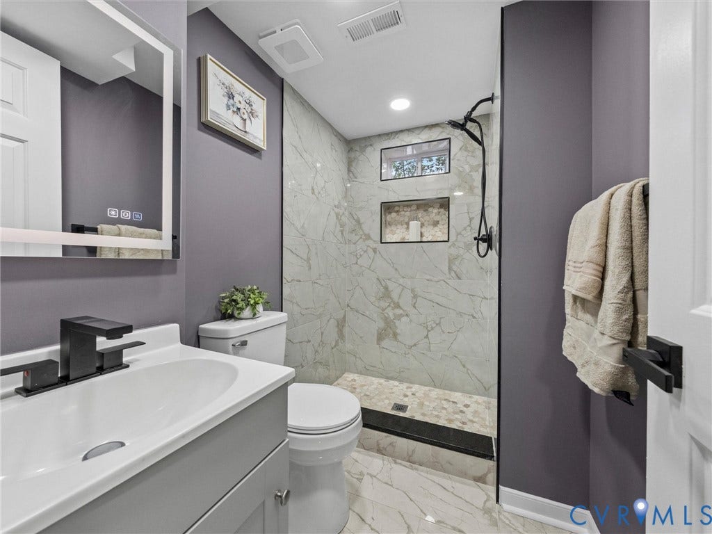 2031 Esquire Road, Midlothian, VA 23235 Modern bathroom featuring a vanity with a rectangular sink, matte black faucet, and illuminated mirror