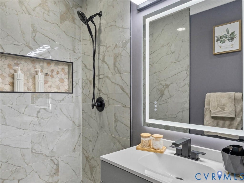 2031 Esquire Road, Midlothian, VA 23235 Tiled shower featuring a matte black showerhead and a built-in niche with mosaic tile