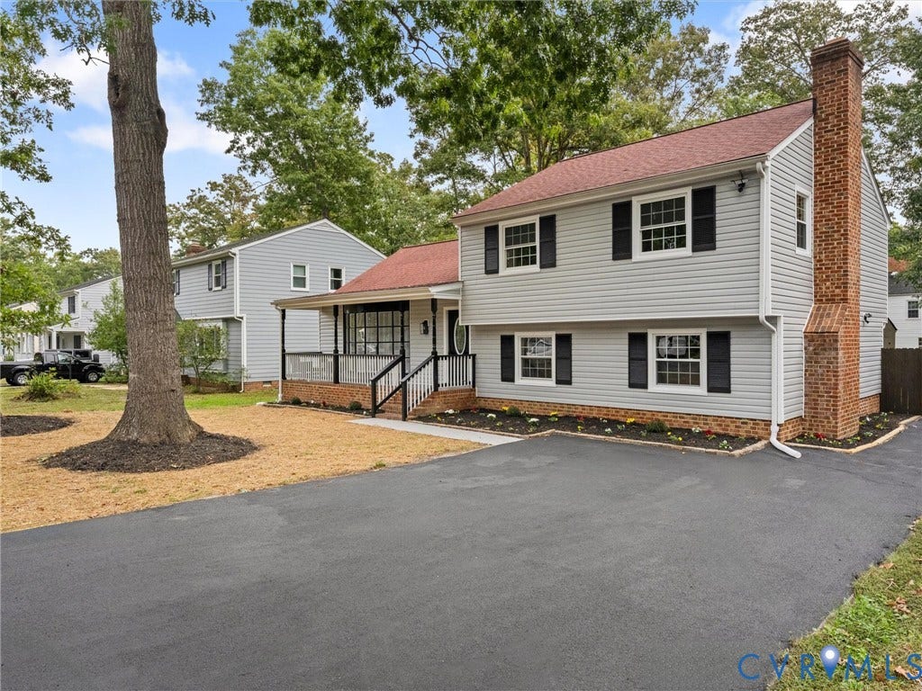 2031 Esquire Road, Midlothian, VA 23235 Two-story residence featuring light gray siding, a red shingle roof, and a prominent brick chimney