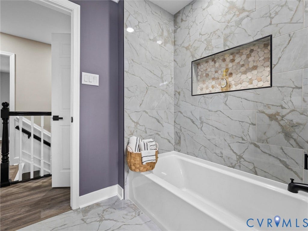 2031 Esquire Road, Midlothian, VA 23235 Bathtub with a black-framed recessed niche featuring mosaic tile