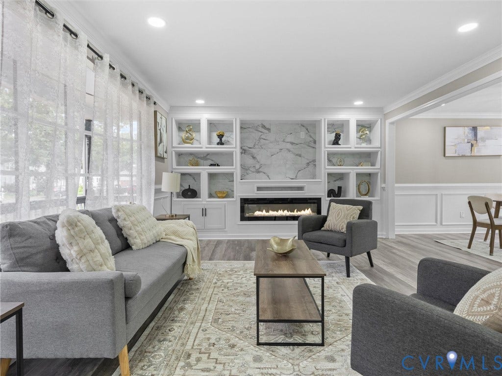 2031 Esquire Road, Midlothian, VA 23235 Built-in shelving with integrated lighting, wood-finish flooring, recessed lighting, electric fireplace, and decorative wainscoting