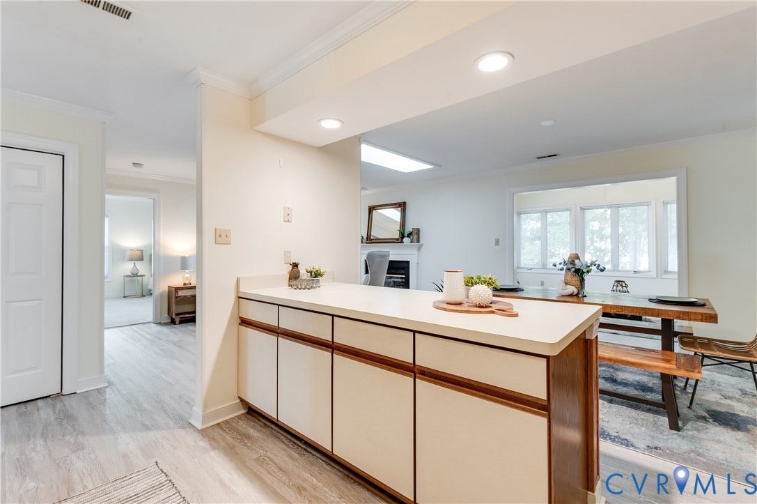 Built-in cabinetry with a light countertop, recessed lighting, and wood-finish flooring