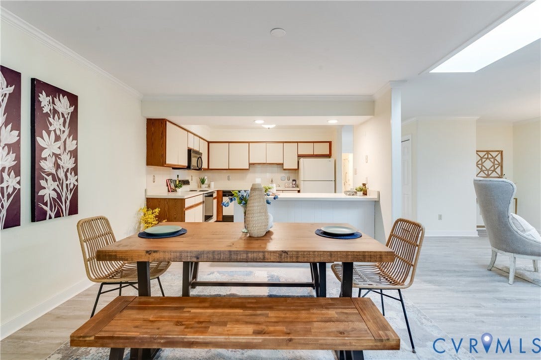 Kitchen featuring white appliances, a white countertop, and wood-finish cabinetry