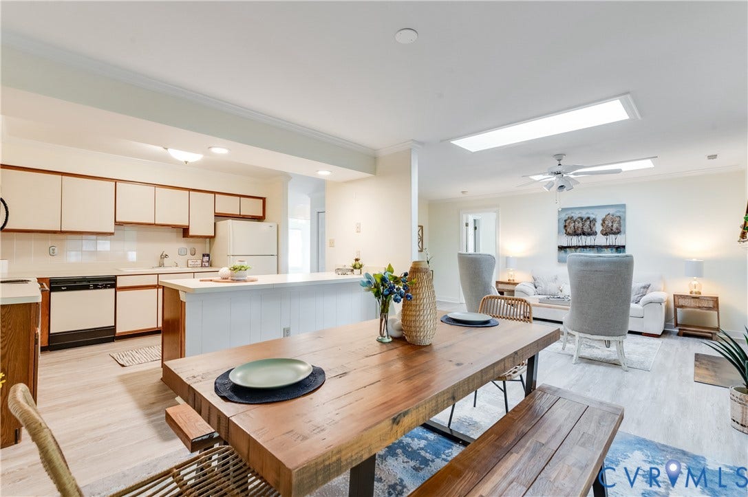 Open-concept living space with light-tone wood-finish flooring
