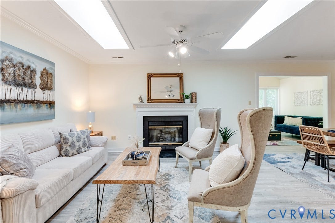 Recessed lighting, crown molding, fireplace with mantel, ceiling fan, and wood-finish flooring