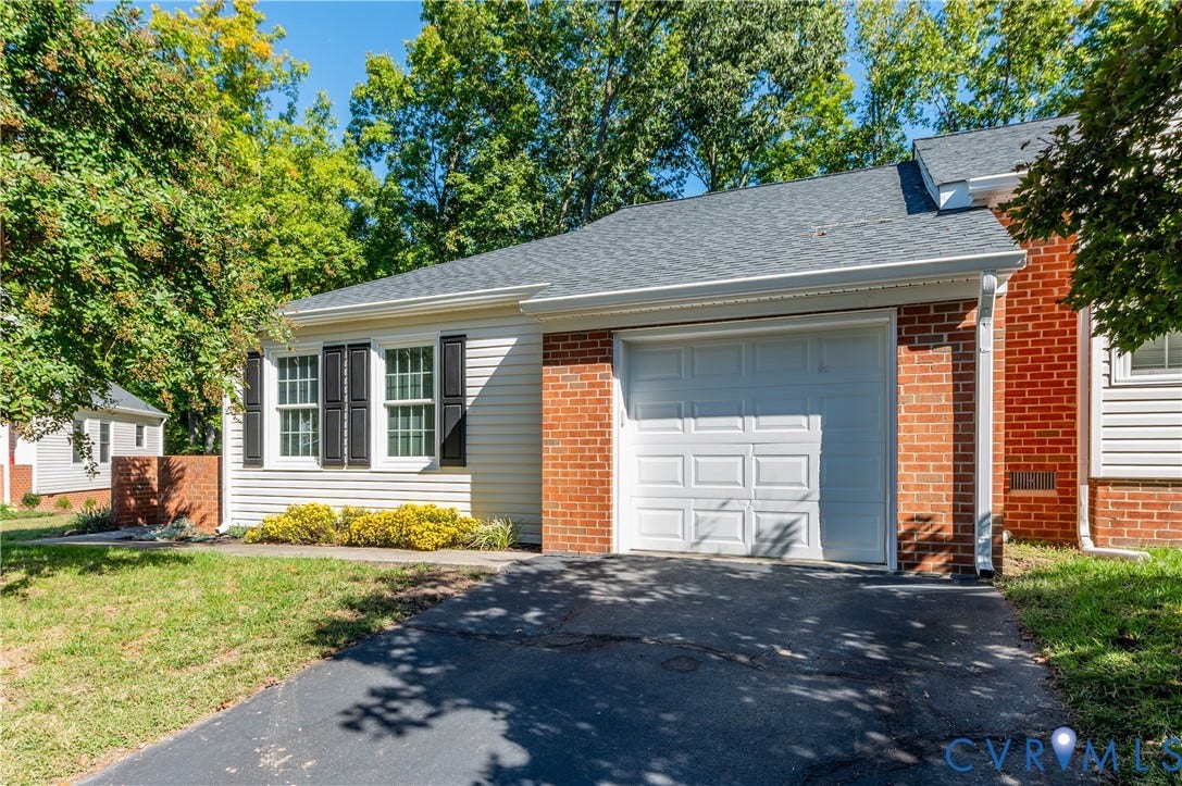 Brick and siding exterior with a shingled roof