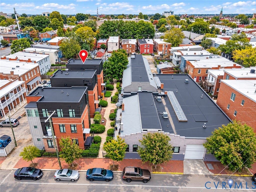 Contemporary townhome architecture featuring brick and paneling facade