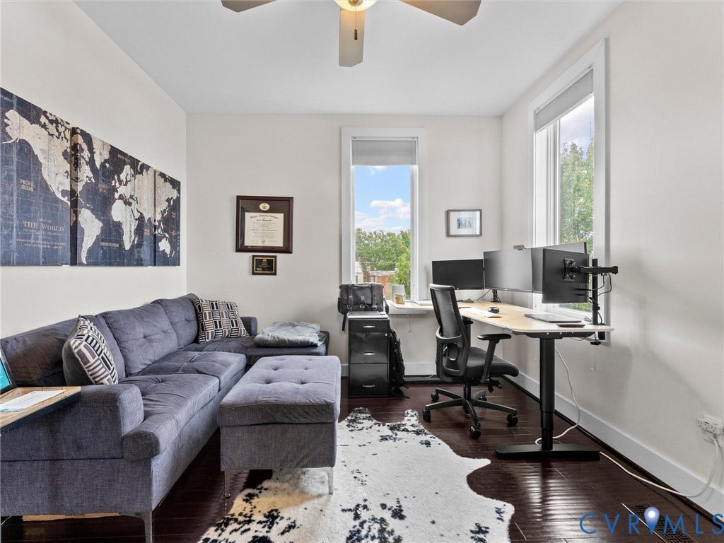 Hardwood-finish flooring, white walls, and a ceiling fan