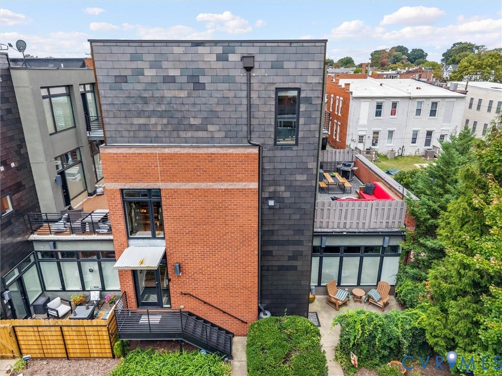 Brick and slate exterior with multiple outdoor living spaces
