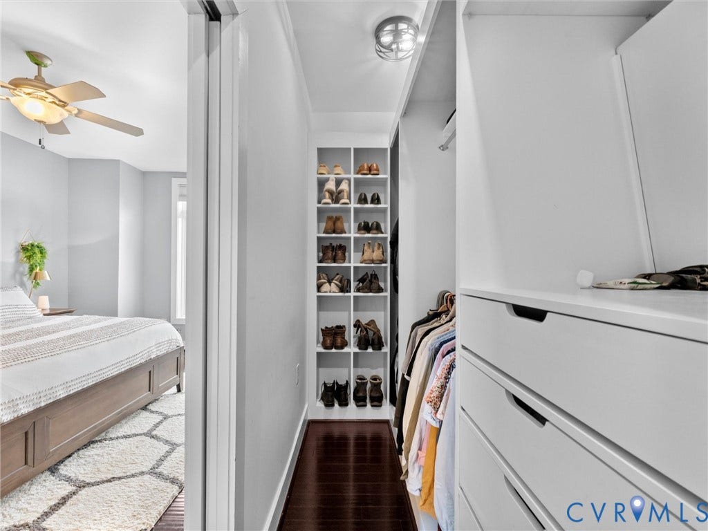 Built-in closet shelving, integrated drawer storage, recessed lighting, and dark wood-finish flooring