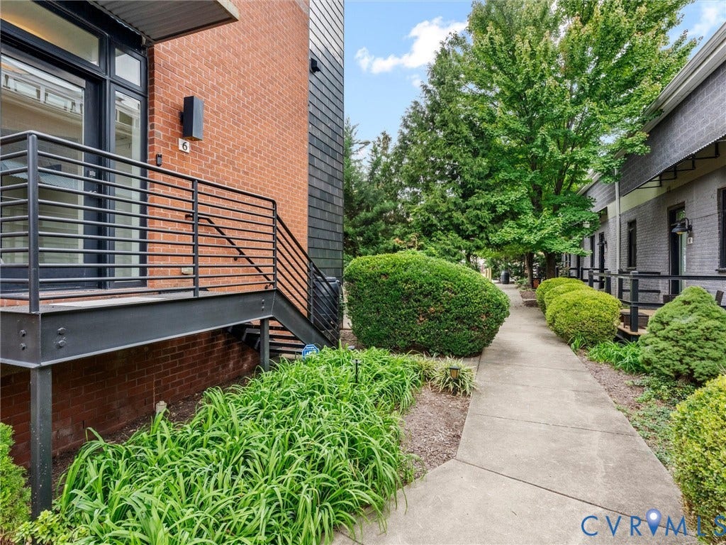 Brick exterior with dark trim and large windows