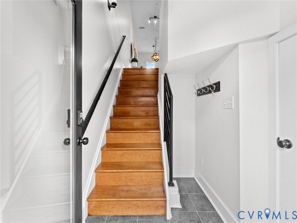 Wood staircase with black metal railings