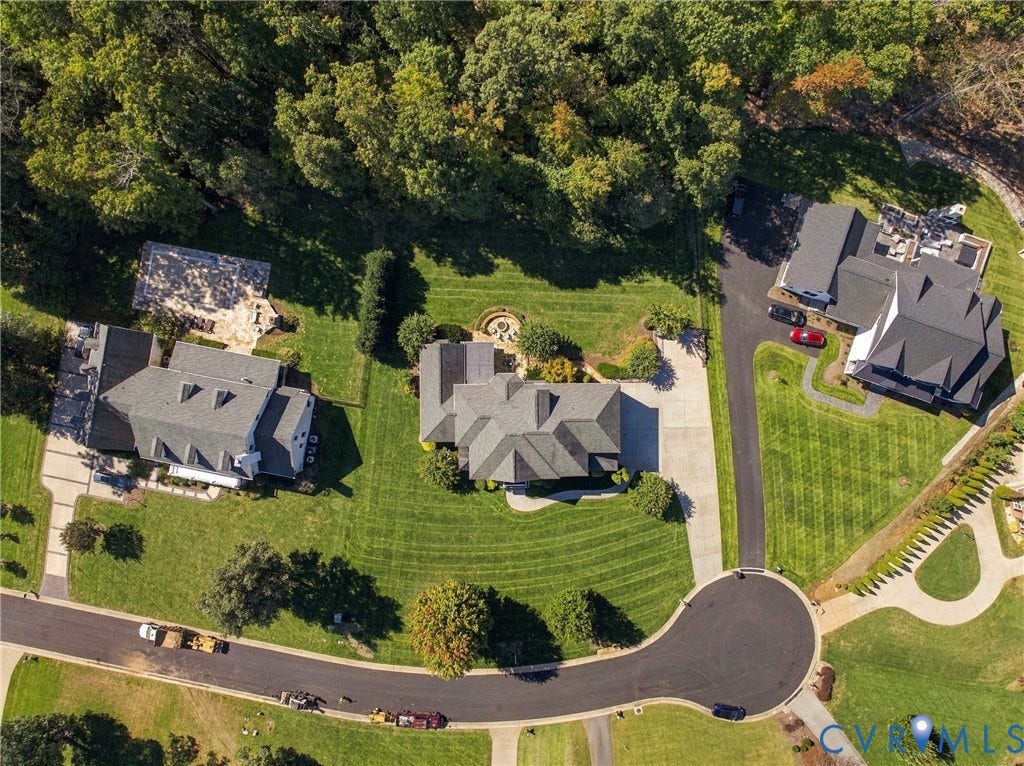 Expansive property featuring a cul-de-sac, multiple residences, and mature tree lines