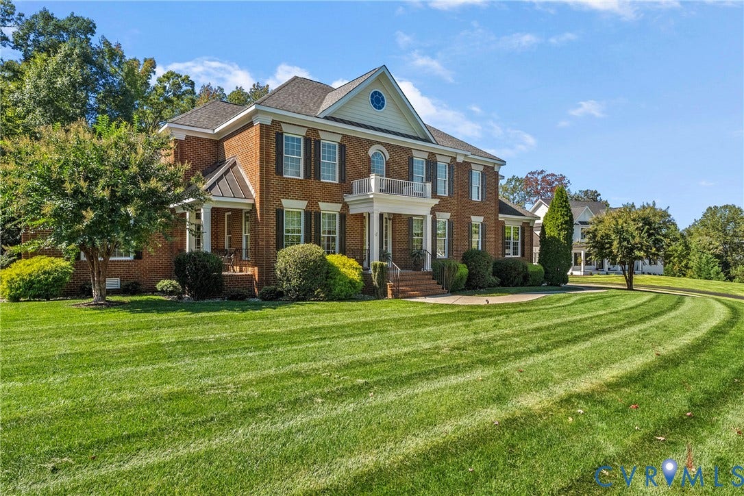 Brick exterior with white columns and contrasting dark shutters