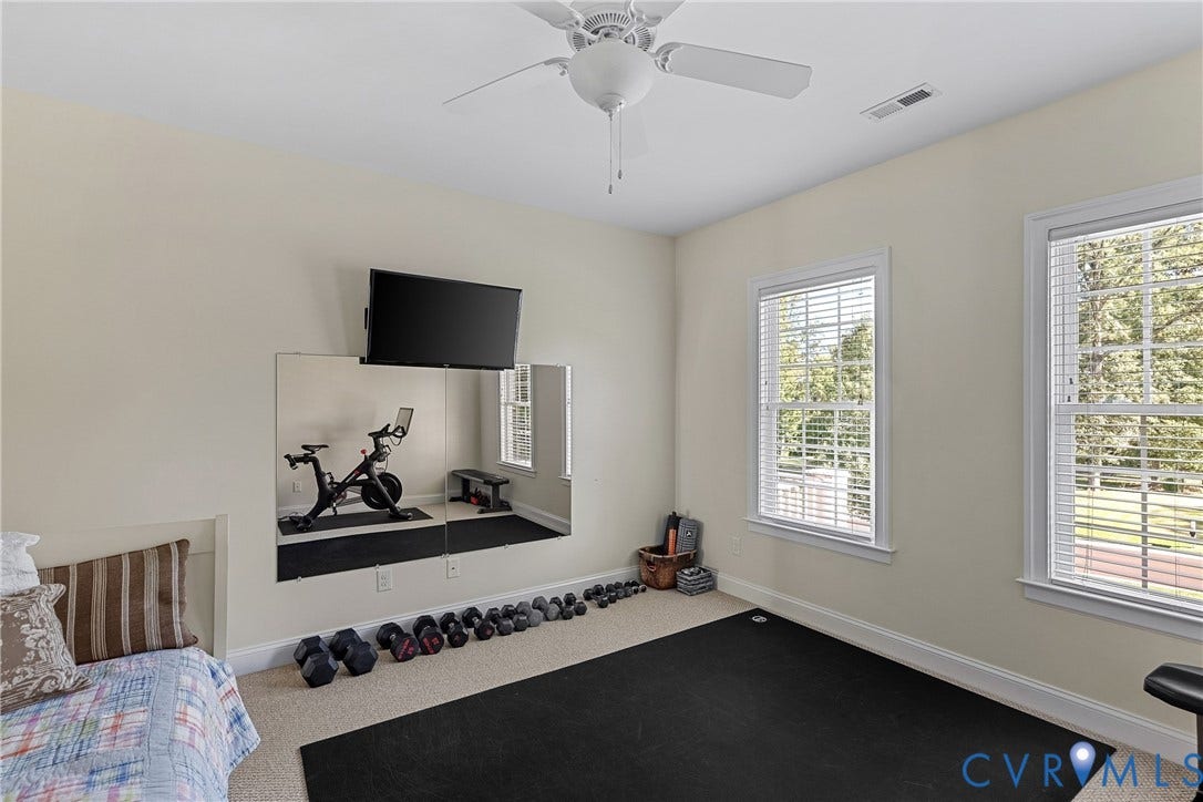 Recessed ceiling fan, carpeted flooring, mirrored wall accent, and two windows with blinds