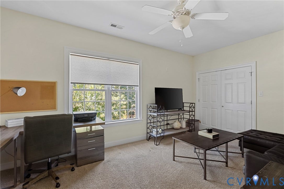 Recessed lighting, ceiling fan, white trim window with roller shade, and bi-fold closet doors