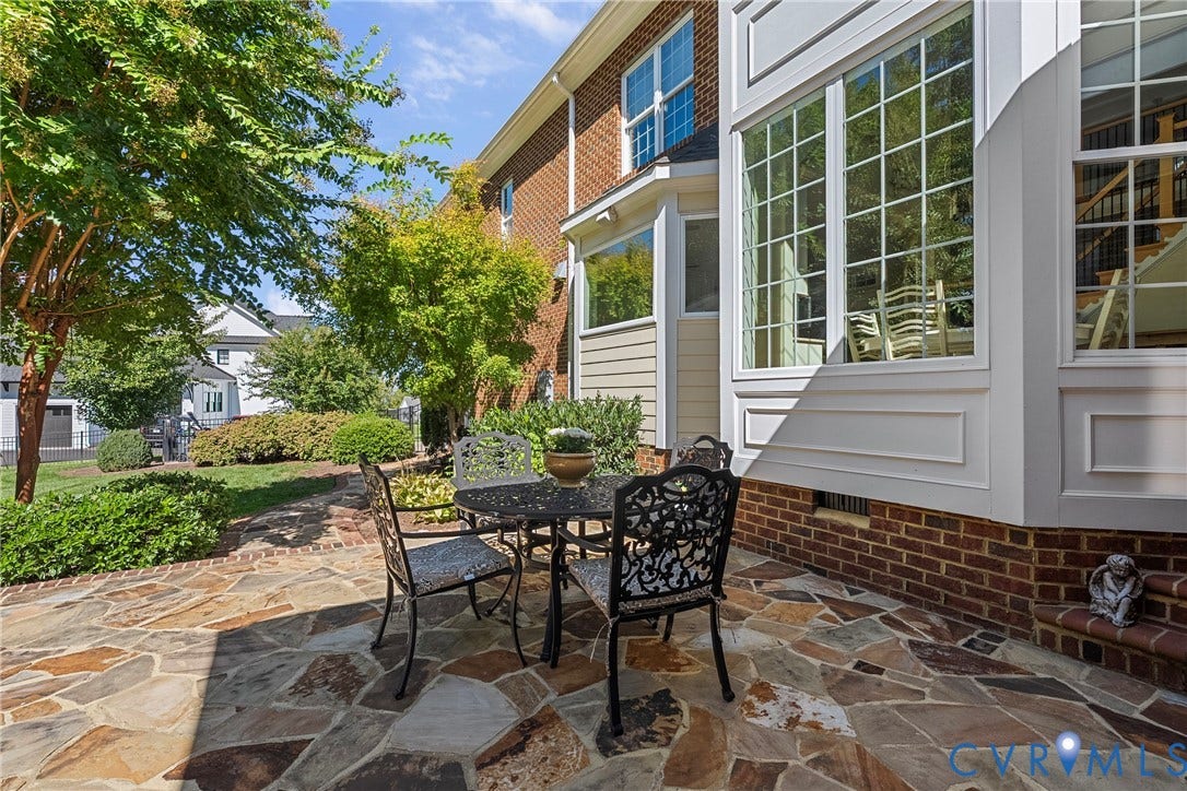 Flagstone patio with a brick foundation and extensive landscaping