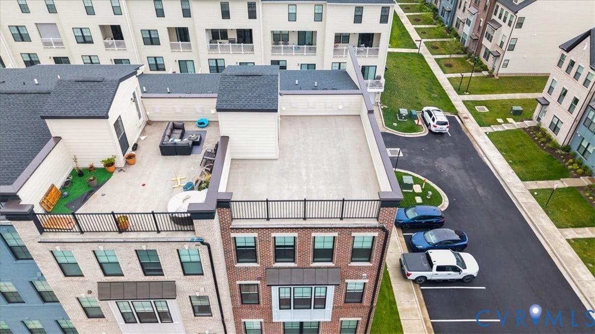 Rooftop deck featuring a black metal railing and a large open-air space