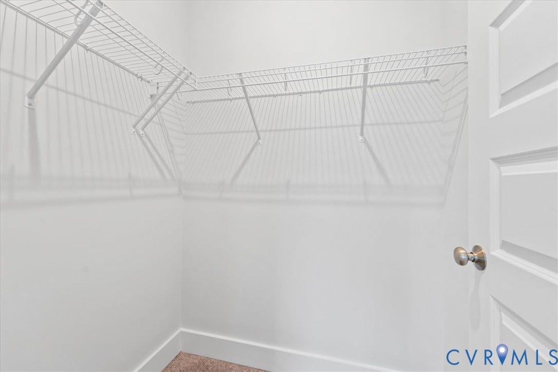 Walk-in closet with white wire shelving