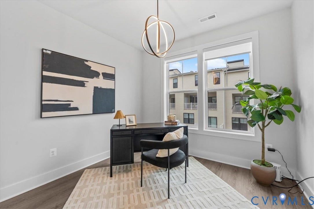 Dual windows with white trim, wood-finish flooring, and a contemporary ceiling fixture