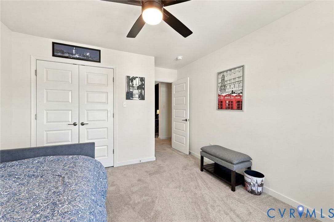 Recessed lighting, ceiling fan with light fixture, light-colored carpeting, two-panel interior doors, and white walls