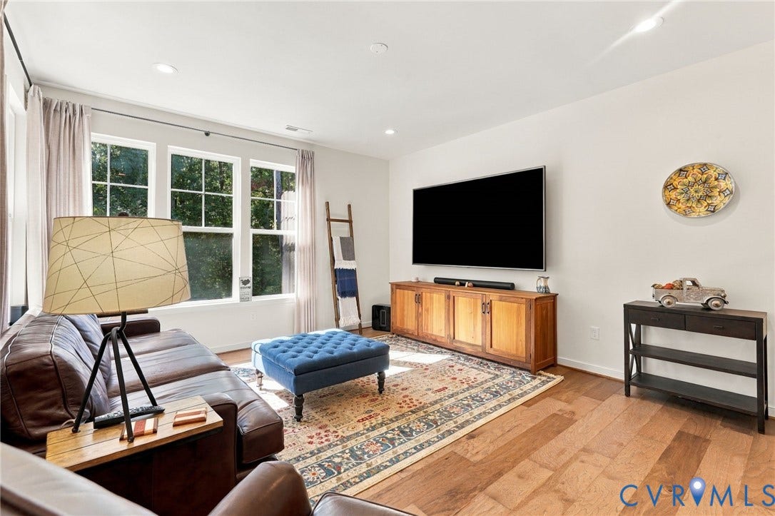 Recessed lighting, wood-finish flooring, and multiple large windows
