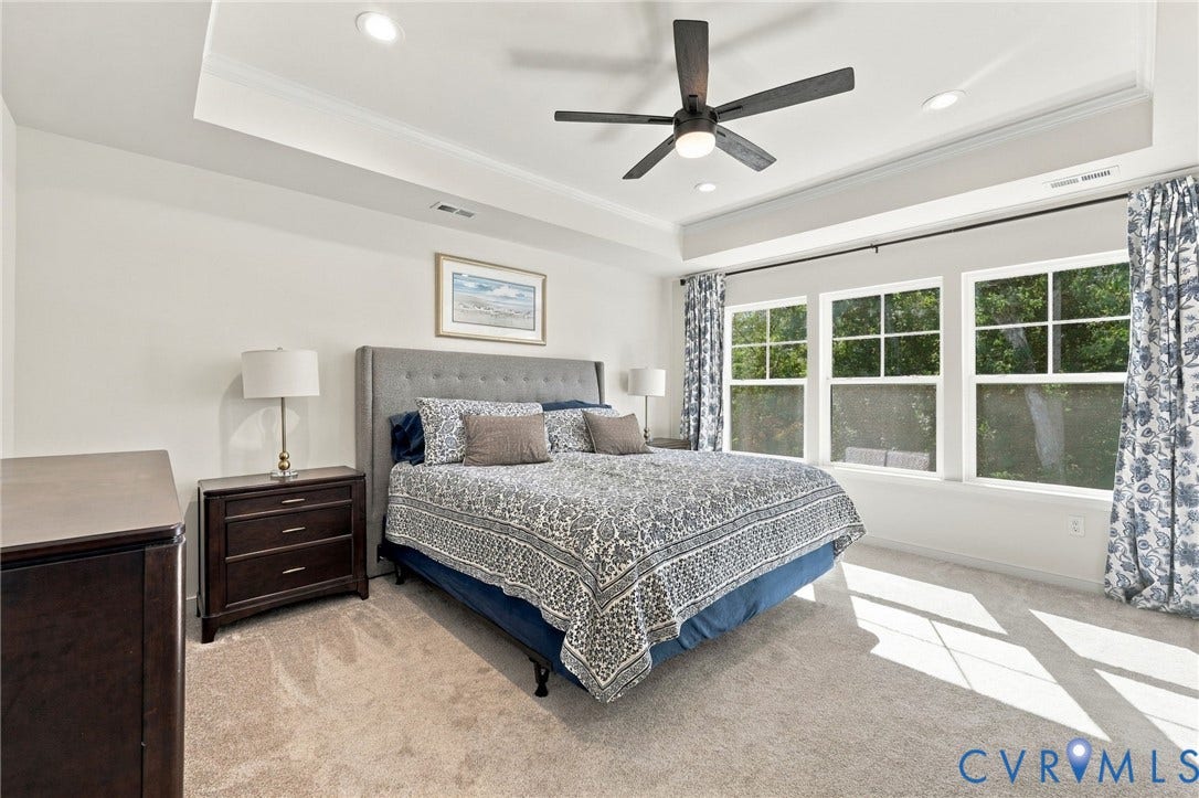 Tray ceiling featuring recessed lighting and a ceiling fan