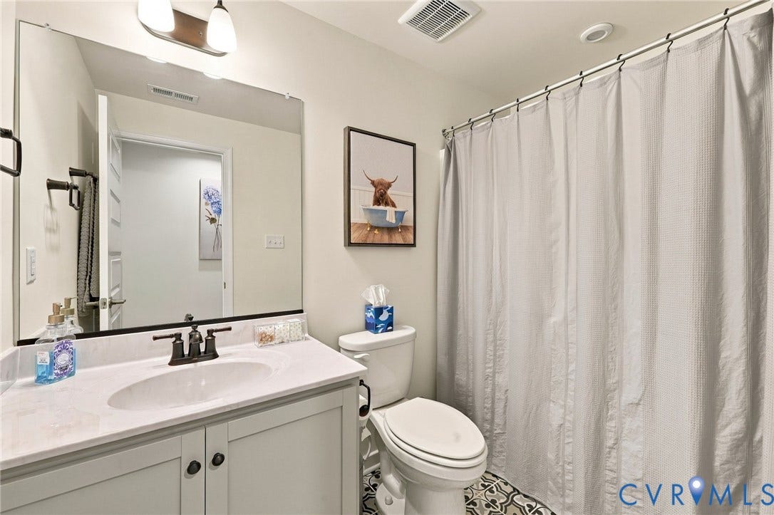 Basement Full Bath,  black-finish faucet, and a large wall-mounted mirror