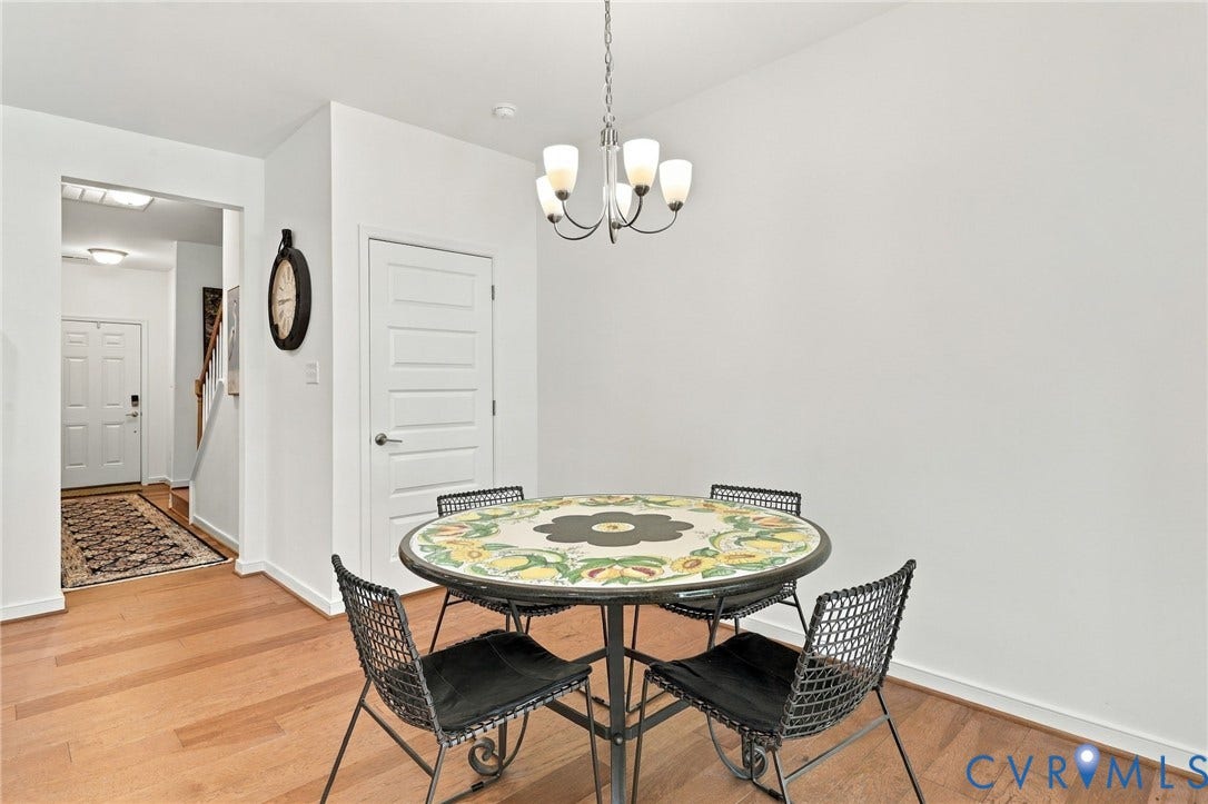 Hardwood flooring throughout, recessed lighting, and a modern chandelier