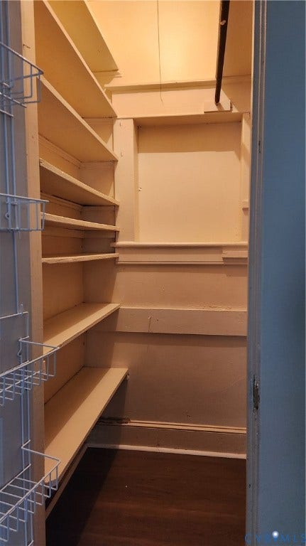 Integrated wire shelving, built-in wooden shelving, and wood-finish flooring