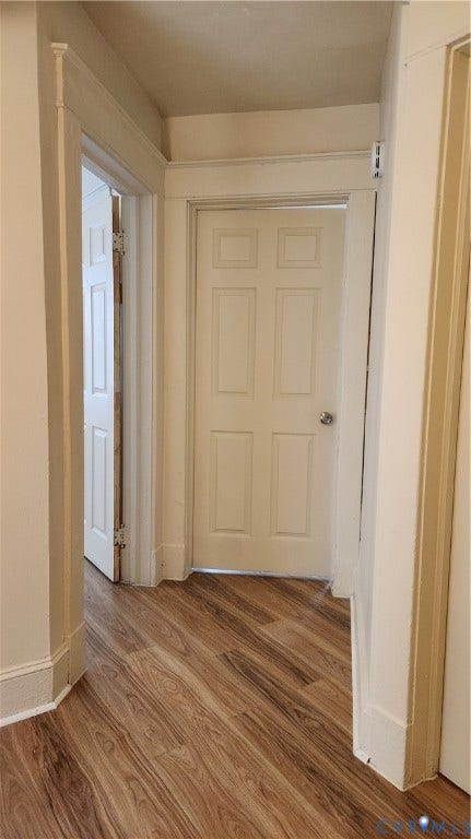 Wood-finish flooring throughout, complemented by white paneled doors and detailed white trim work