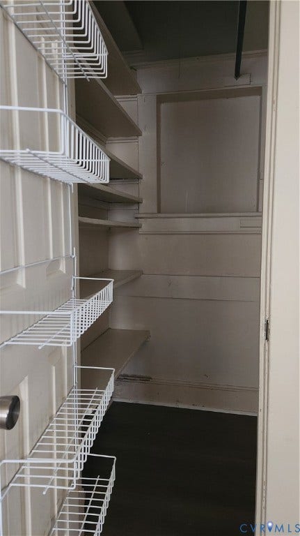 Built-in shelving and door-mounted wire racks provide storage