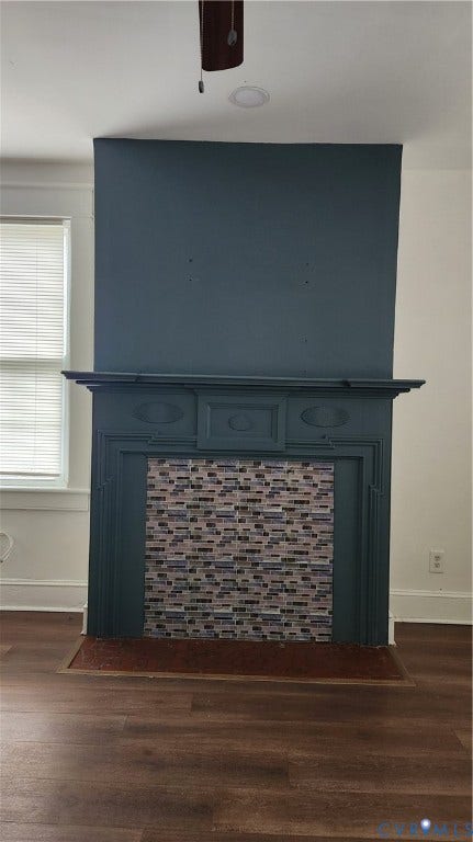 Decorative fireplace with a tile surround, painted mantel, and wood-finish flooring