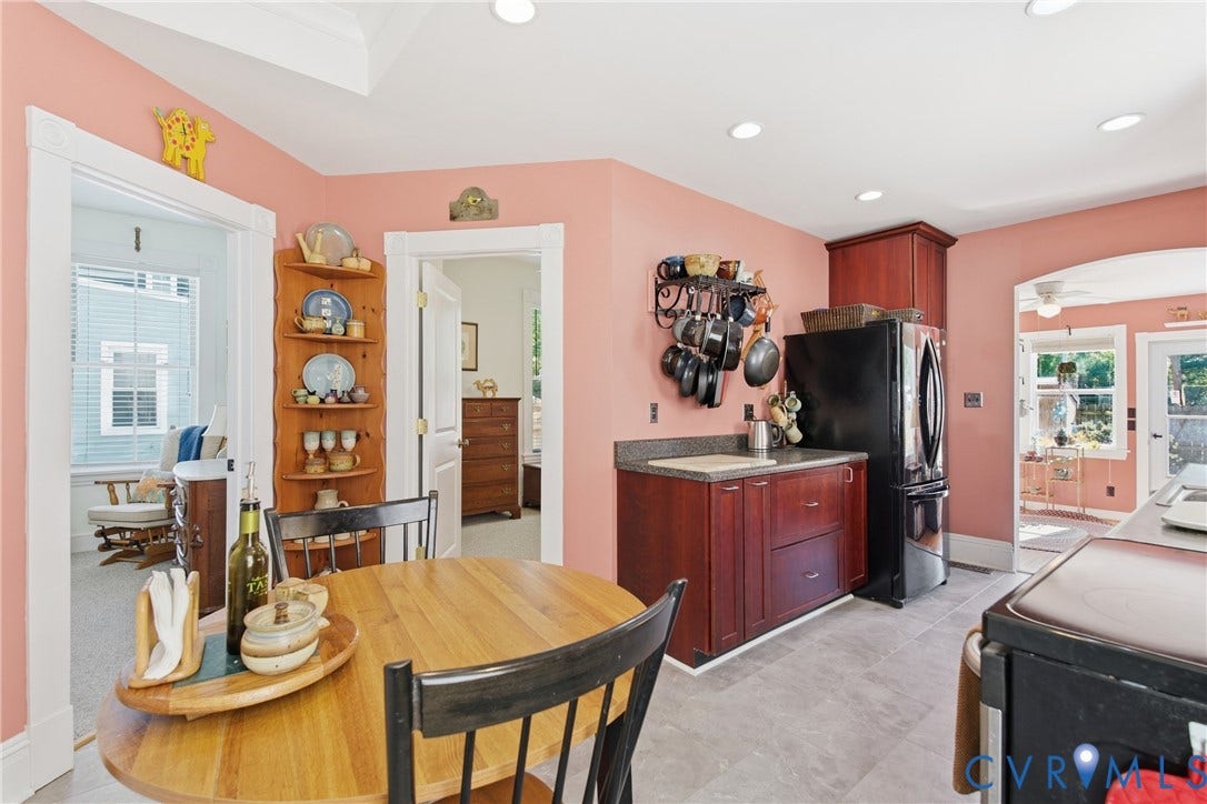 Kitchen featuring wood-finish cabinetry, a freestanding refrigerator, and recessed lighting