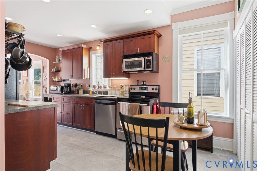 Kitchen featuring wood cabinetry, stainless steel appliances, recessed lighting, and tile flooring