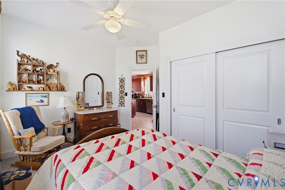 Recessed ceiling fan with integrated lighting, painted white walls, recessed closet with sliding panel doors, and carpeted flooring