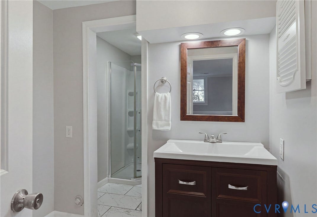 55 Dehaven Drive, Henrico, VA 23238 Bathroom featuring a dark wood-finish vanity with white sink, brushed nickel faucet, framed mirror, and recessed lighting