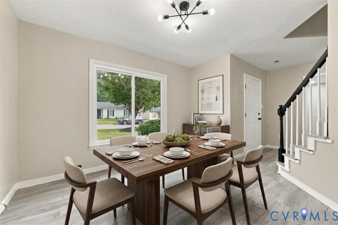 5831 Larrymore Road, Richmond, VA 23225 Wood-finish flooring, large sliding window, contemporary geometric chandelier, and staircase with painted black handrail and white balusters
