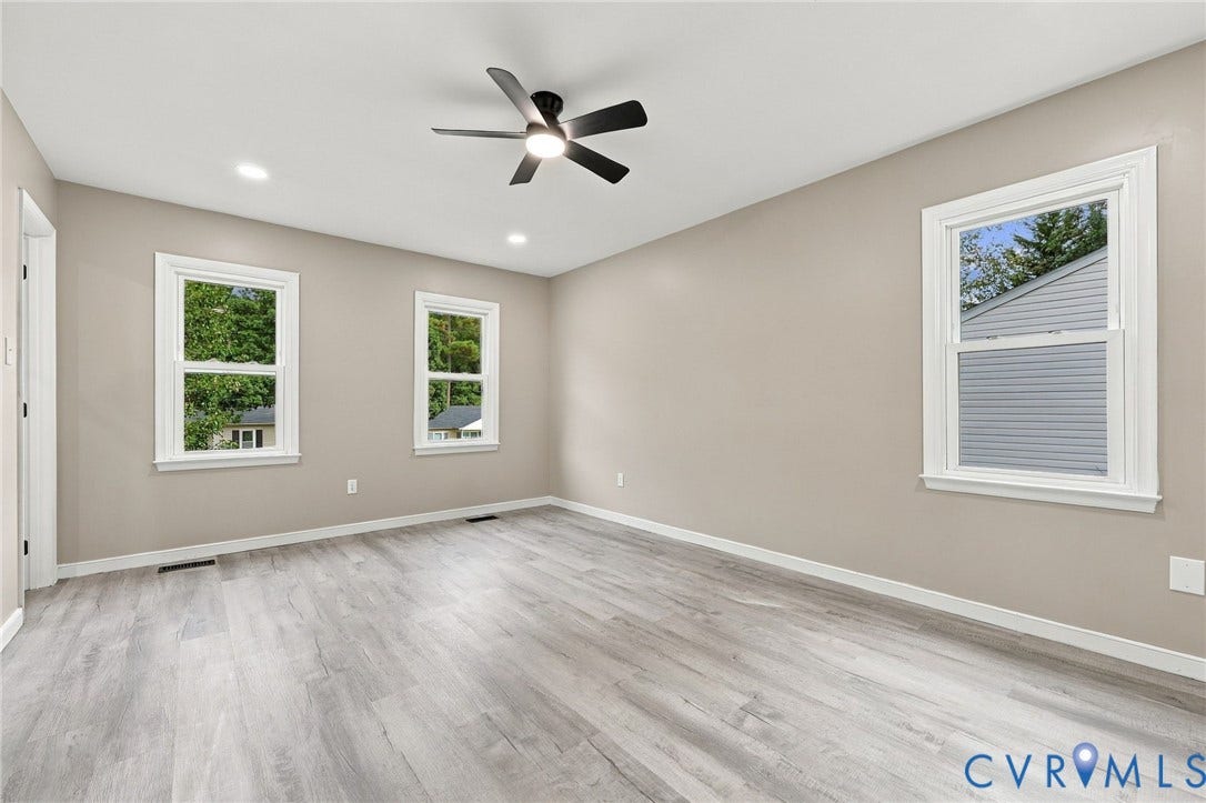 5831 Larrymore Road, Richmond, VA 23225 Neutral wall color, wood-finish flooring, recessed lighting, and a ceiling fan with integrated lighting